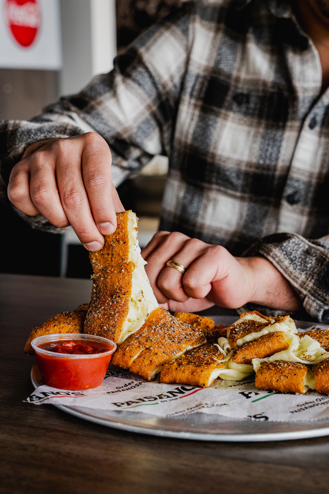 Pulling apart Paisano’s cheesy bread with a side of marinara