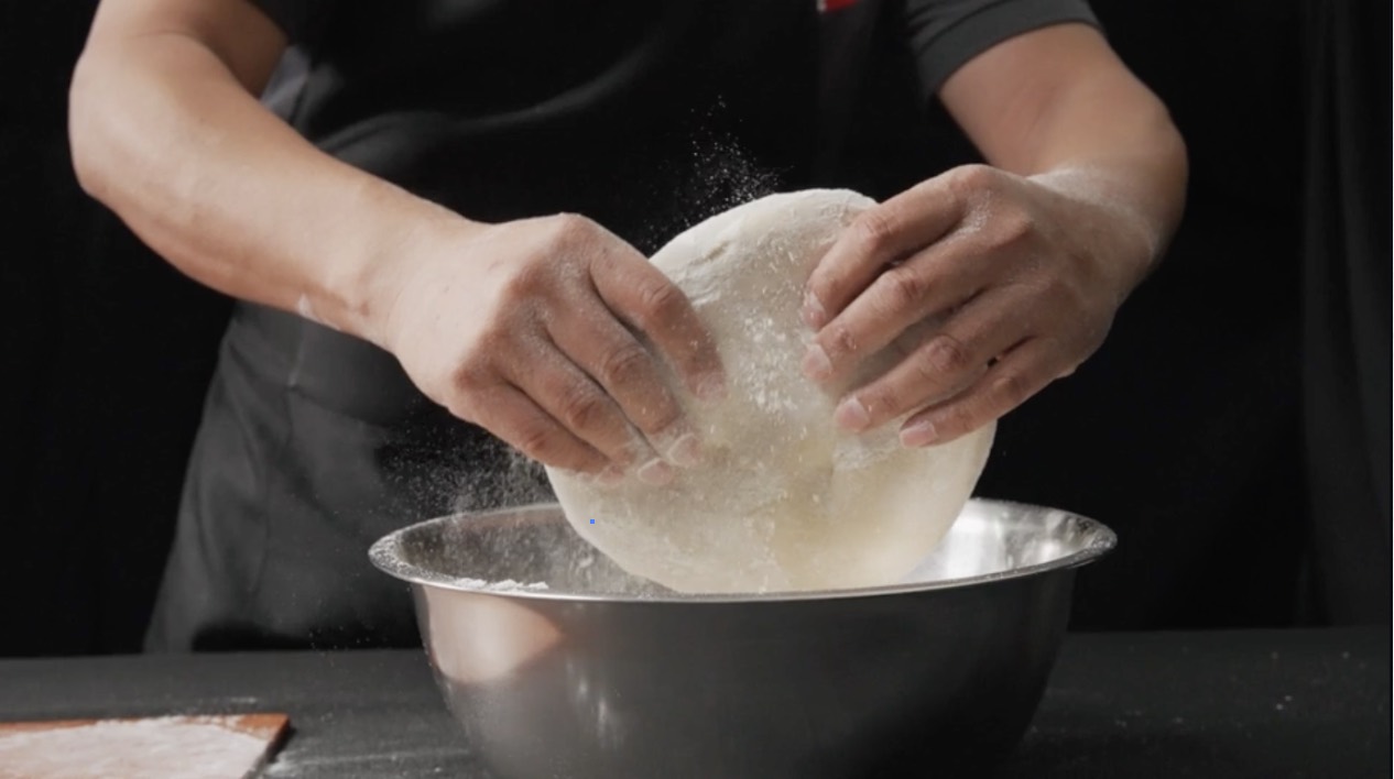 Fresh dough being stretched in a Paisano's kitchen
