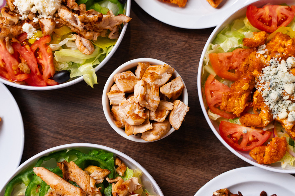 Paisano’s salads topped with grilled and buffalo chicken