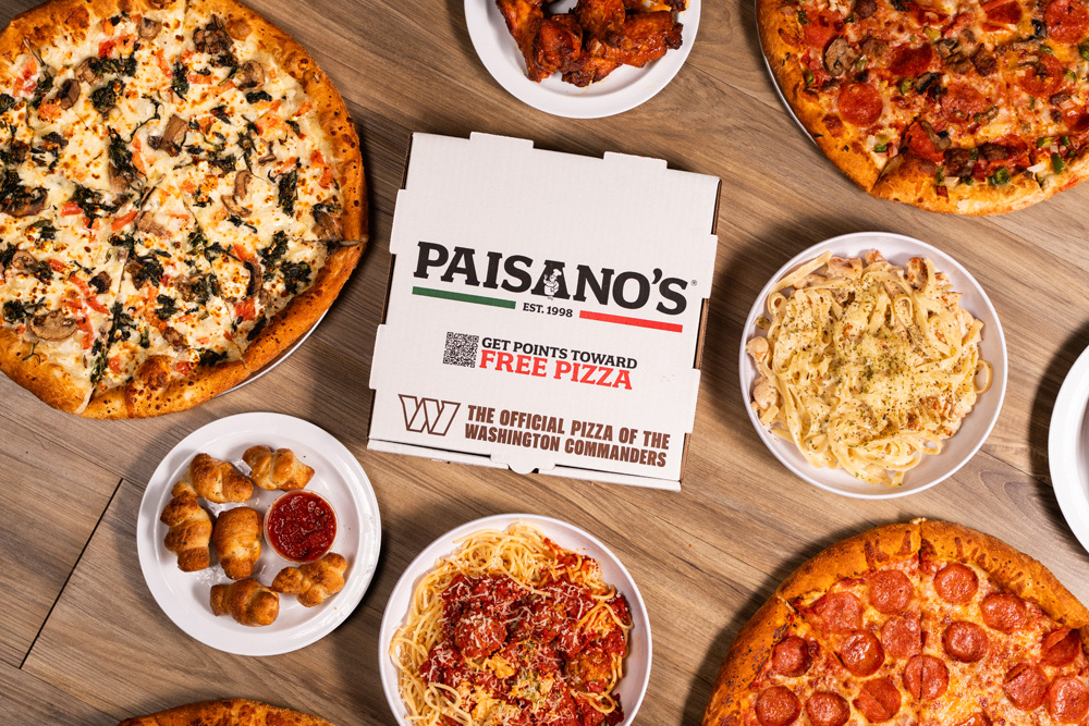Paisano’s pizzas, pasta, and garlic knots around a pizza box that reads The Official Pizza of the Washington Commanders